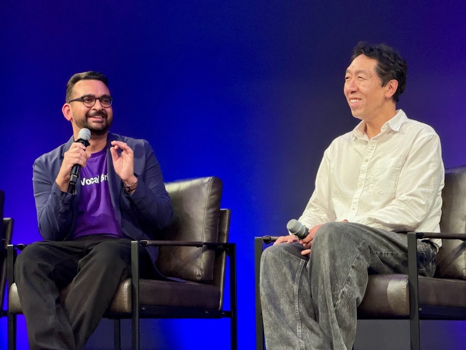 Ashwyn Sharma and Andrew Ng laughing together during an on-stage conversation